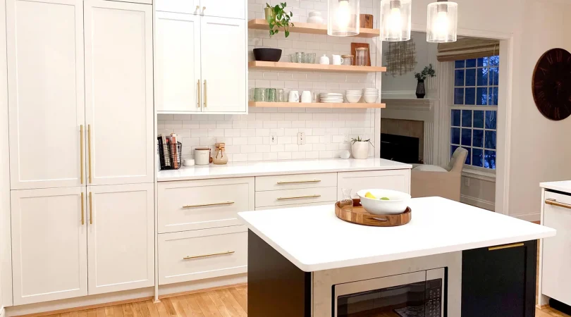 White Shaker wall cabinets and Black Shaker island in a kitchen remodel