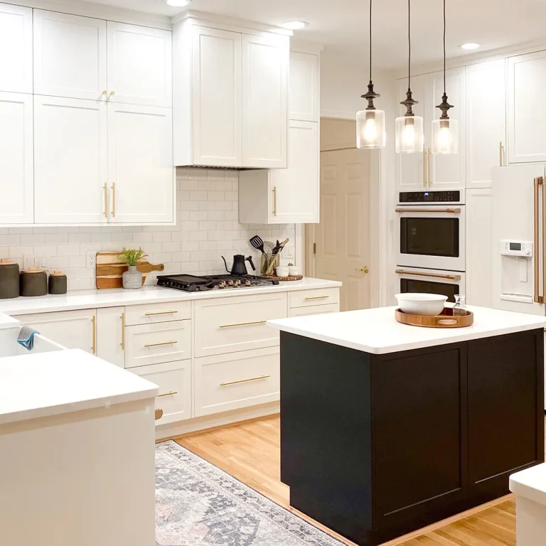 White Shaker wall cabinets and Black Shaker island in a kitchen remodel